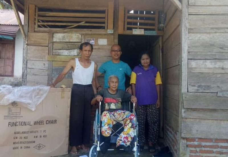 Bupati BS saat menyerahkan bantuan kursi roda kepada warga yang membutuhkan 